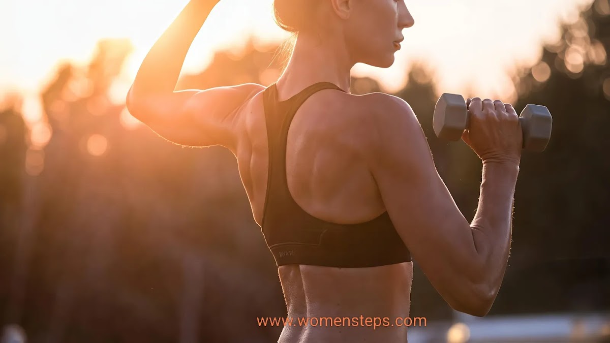 Woman working out with dumbbells for shoulder and back definition.
